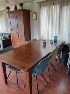 a wooden table and chairs in a room at Bospark Lunsbergen - LB 76 in Borger