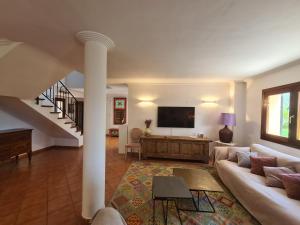 a living room with a couch and a tv at VILLA JACELIA in Sa Pobla