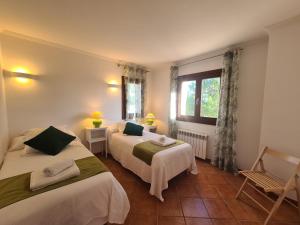a hotel room with two beds and a window at VILLA JACELIA in Sa Pobla +41 photos