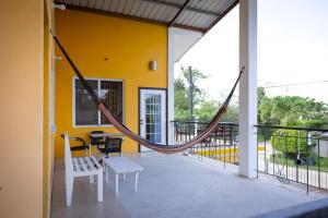 eine Veranda mit Hängematte auf einem Haus in der Unterkunft Cozy Flat in San Ignacio Close to Downtown! in San Ignacio