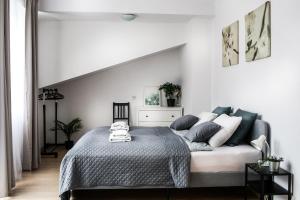 a bedroom with a bed in a white room at Fully-furnished Apartment with Air Conditioning for families, Cracow Old Town in Kraków