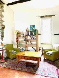a living room with two chairs and a coffee table at Grande maison cévenole authentique in Valleraugue +32 photos