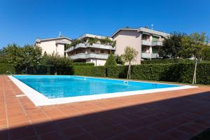 a swimming pool in front of a building at Patty14 By Case al Lago in Sirmione