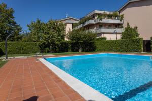 a swimming pool in front of a house at Patty14 By Case al Lago in Sirmione +16 photos