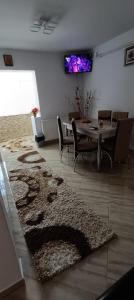 a living room with a table and a rug at Piano Apartament in Gura Humorului