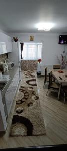 a kitchen and living room with a rug on the floor at Piano Apartament in Gura Humorului