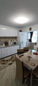 a kitchen with a table and chairs in a room at Piano Apartament in Gura Humorului