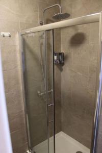 a shower with a glass door in a bathroom at Kildare House Hotel in Kildare