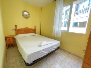 a small bedroom with a bed and a window at Apartamentos Costa Azahar 3000 in Alcossebre +69 photos