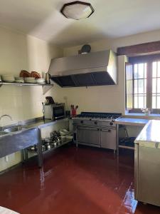 a large kitchen with stainless steel appliances and counters at Casa BellaTerra in Villasana de Mena