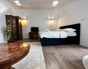 a bedroom with a large bed and a table at Most in Slavonski Brod