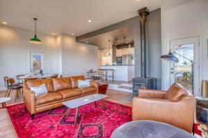 a living room with leather furniture and a fireplace at Walters Waldport in Waldport