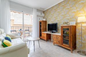 een woonkamer met een tv en een bank bij Legado Marino in Santa Pola