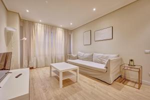 a living room with a couch and a table at La paz home by Clabao in Logroño
