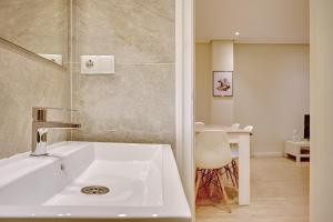 a bathroom with a white sink and a table at La paz home by Clabao in Logroño +22 photos