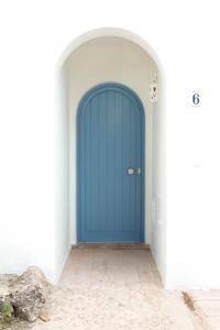 una puerta azul en una habitación de paredes blancas en A Casa da Porta Azul, en Porches