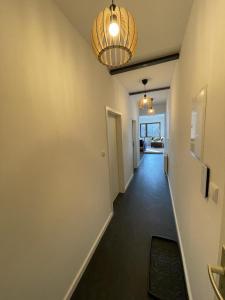 a hallway leading to a living room with a light fixture at Haus Charlottenburg 3, zentrumsnah gelegen, mit Blick auf die Festung, mit Sauna Option in Königstein an der Elbe