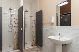 a bathroom with a sink and a shower at Albergue Hostel Llanes in Llanes