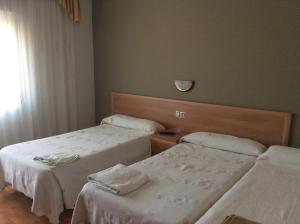 Postel nebo postele na pokoji v ubytování Hostal Juli