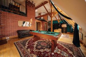 a room with a pool table and a brick wall at Billionaires Club LOFT Sauna City Center in Prague