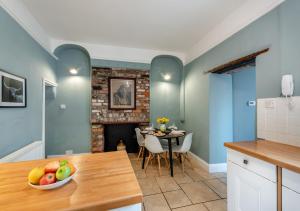 a kitchen and dining room with a table and a fireplace at Ship Ahoy in Appledore