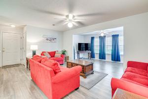 a living room with red furniture and a ceiling fan at Murrells Inlet Condo with Pool Access, Near Beach! in Myrtle Beach