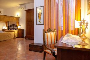 a room with a desk and a bed and a bedroom at Donnaciccina Accomodation in Tropea