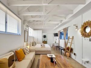 een woonkamer met een bank en een bed bij Unique Studio Close to Promenade in Kaapstad
