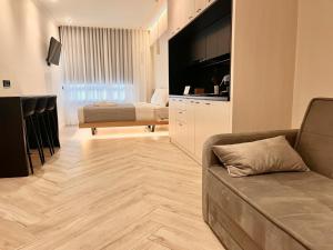 a living room with a couch and a bed at Triple A - Stylish Seven On The Pedestrian - FREE Parking! in Athens