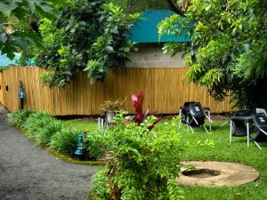 a backyard with chairs and a fence and a yard with plants at Kizumba House in Arusha