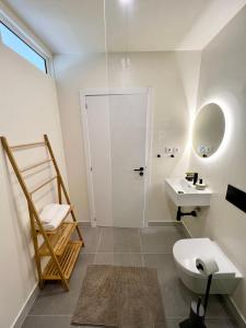 a bathroom with a toilet and a sink at Sunday Morning Guesthouse in Aljezur +45 photos