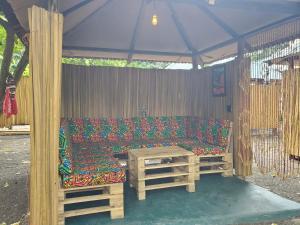 a couch sitting under a tent with a table at Kizumba House in Arusha