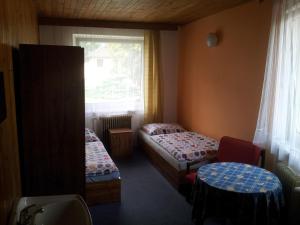 Posteľ alebo postele v izbe v ubytovaní Penzion Tenis