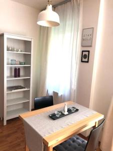 a dining room with a table and a window at P19 Apartment in Budapest