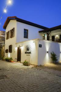 a white building with a sign on the side of it at NİYAMA MARİNA Butik Hotel in Çeşme