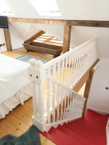 a white staircase in a room with a bed at Prestwick Oak - 3 King Bed Ensuite Quirky Contemporary in Chiddingfold