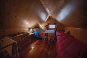 a room with two beds in a wooden attic at Rifugio del volpacchiotto - Piano Battaglia in Petralia Sottana