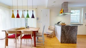 a kitchen and dining room with a table and chairs at Villa am Kurpark in Binz