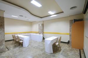 a conference room with white tables and chairs in it at Hotel Vermont Ipanema in Rio de Janeiro