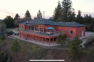 an aerial view of a large red house at Stunning Mountaintop Resort in Placerville