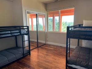 a room with three bunk beds and a window at Stunning Mountaintop Resort in Placerville