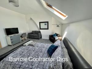 a bedroom with a bed and a couch and a tv at Barrow Contractor Digs, Serviced Accommodation, Home from Home in Barrow in Furness
