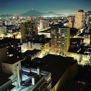 Blick auf eine Stadt in der Nacht mit Gebäuden in der Unterkunft Gran Santiago Apart in Santiago