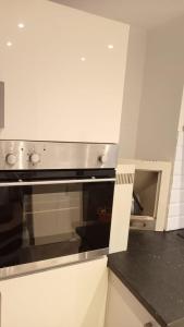a kitchen with a stove top oven in a kitchen at Bike Park 5 miles2-Bed cottage in Merthyr Vale in Merthyr Tydfil