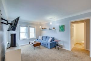 a living room with a blue couch and a tv at Convenient Cleveland Abode with Office and Home Gym in Cleveland