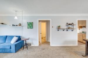 a living room with a blue couch and a table at Convenient Cleveland Abode with Office and Home Gym in Cleveland