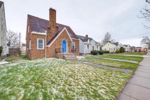 a brick house with a blue door at Convenient Cleveland Abode with Office and Home Gym in Cleveland