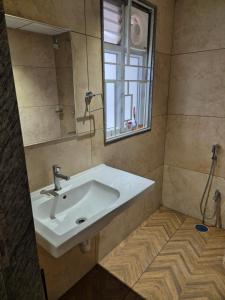 a bathroom with a white sink and a mirror at Swayamkrushi 2nd Floor in Hyderabad +18 photos