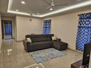 a living room with a couch and a rug at Swayamkrushi 2nd Floor in Hyderabad