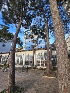 a building with trees in front of it at BLUE AMR in Durrës